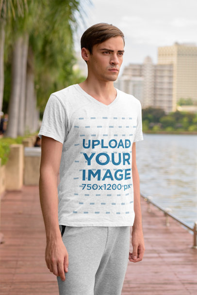 V-Neck T-Shirt Mockup of a Serious Man Standing by a River 