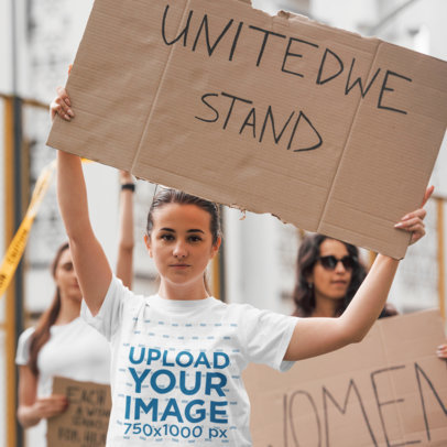 T-Shirt Mockup of a Woman at a Peaceful Protest with a Cardboard Sign 