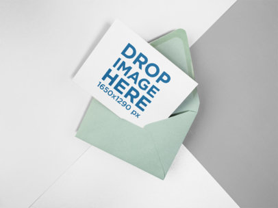 Invitation on an Envelope Mockup Lying on a Three Colors Background