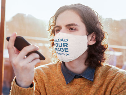 Face Mask Mockup of a Man on a Phone Call at a Coffee Shop