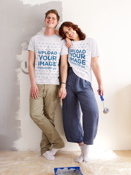 T-Shirt Mockup of a Young Couple Painting a Wall Together