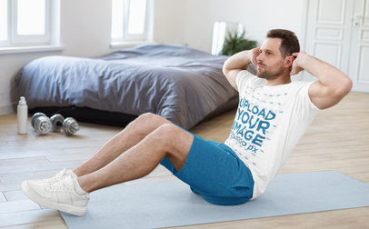 T-Shirt Mockup of a Man Doing Abs Crunches in His Room