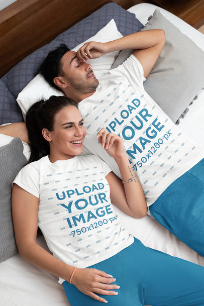 T-Shirt Mockup Featuring a Couple in Their Bedroom Wearing Pajamas