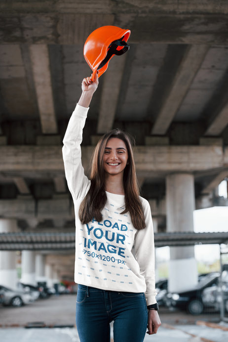 Sweatshirt Mockup of a Happy Young Engineer Holding Her Helmet