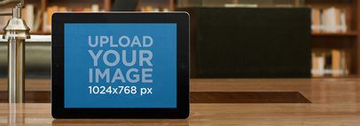 Mockup of a Black iPad inside a Library Placed in Landscape Position