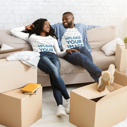 Long Sleeve Tee Mockup of a Couple Relaxing on the Couch by Moving Boxes