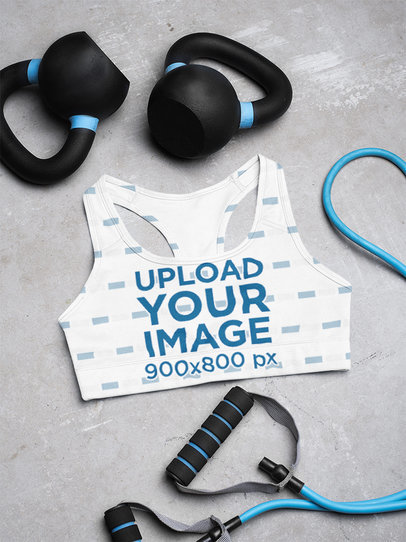 Mockup of a Sublimated Sports Bra Lying by Some Weights
