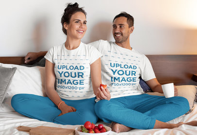 Pajamas T-Shirt Mockup of a Happy Couple Watching TV in their Bedroom