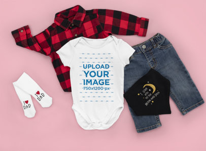 Onesie Mockup Featuring a Baby Boy's Outfit and a Customizable Background m1152