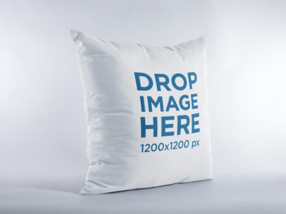 Mockup of a Square Pillow Standing in a White Environment