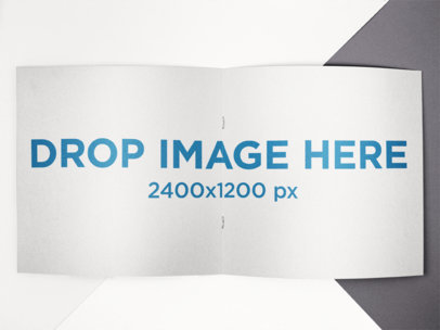 Open Square Booklet Mockup Lying on a Tricolor Surface