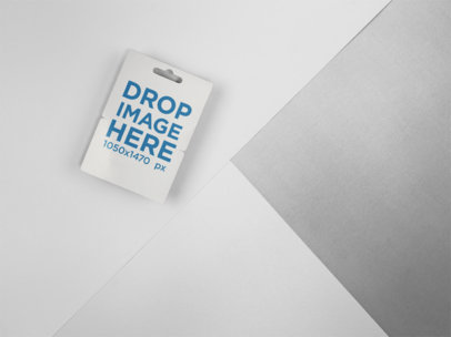 Mockup of a Gift Card Lying on a Surface with Three Colors