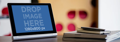 Mockup of an Android Tablet Placed over a Wooden Desk in Landscape Position