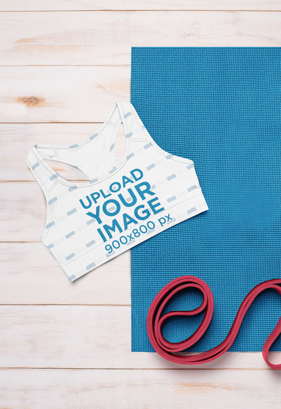 Mockup Featuring a Sublimated Sports Bra and Fitness Accessories 
