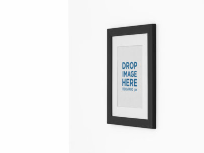 Mockup of a Framed Art Print on a Wall From a Side 