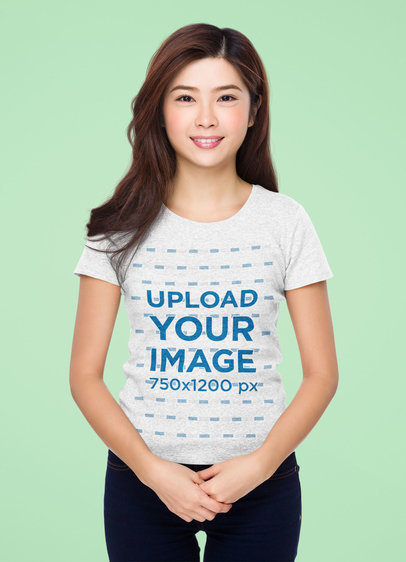 T-Shirt Mockup Featuring a Smiling Woman Standing in a Studio 