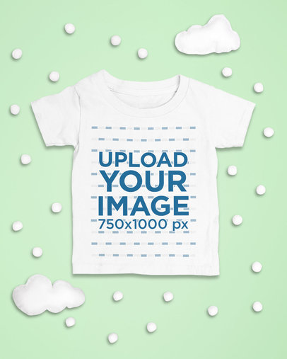 Mockup of a Baby's T-Shirt Laid Flat with Snowy Clouds as an Ornament m1126