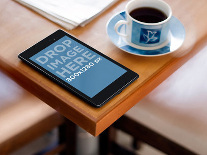 Mockup of a Nexus 7 in Portrait Position Placed on a Wooden Table
