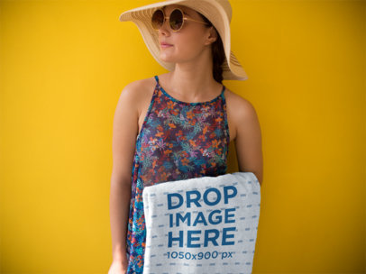 Young Girl Holding a Towel Template While Against a Yellow Background a14894