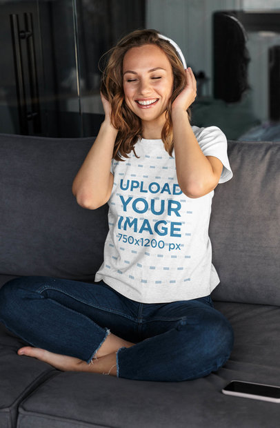 T-Shirt Mockup Featuring a Woman Listening to Music at Home 