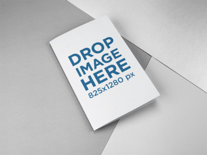 Bifold Brochure Mockup Lying on a Surface with Three Colors