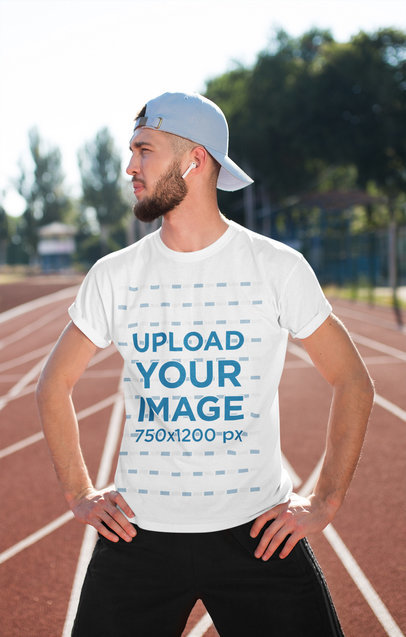 Round-Neck Tee Mockup of a Man Standing on a Running Track