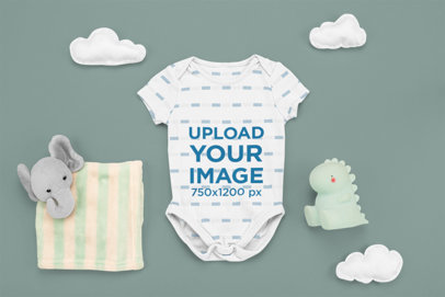 Mockup of a Baby Onesie with an Elephant Plushie and a Dragon Toy m1121