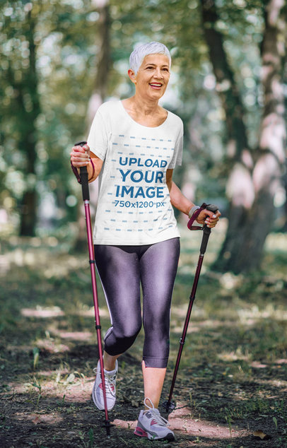 T-Shirt Mockup of a Senior Woman Enjoying a Hike in the Woods