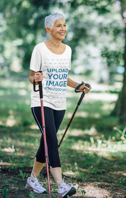 T-Shirt Mockup Featuring a Senior Woman Hiking 