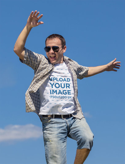 T-Shirt Mockup Featuring a Man Jumping Happily Outdoors