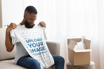 Mockup of a Man Unpackaging a New T-Shirt 39564-r-el2