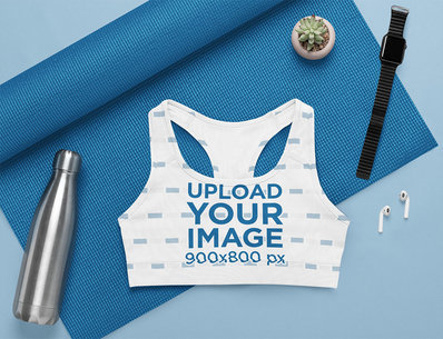 Flat Lay Mockup of a Sublimated Sports Bra in a Yoga Setting