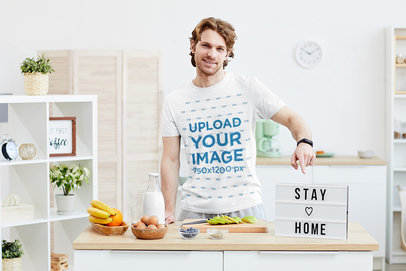 T-Shirt Mockup Featuring a Man Cooking at Home