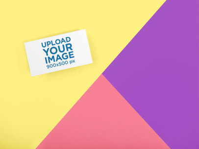 Mockup of a Business Card Lying on a Three Colors Surface