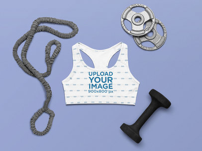 Mockup of a Sublimated Sports Bra Placed Among Fitness Accessories 