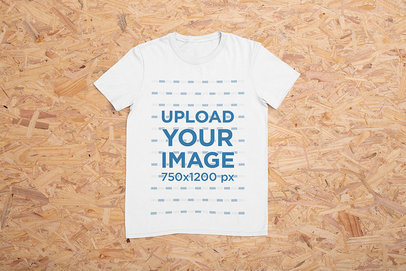 Mockup of a Basic T-Shirt on a Wooden Surface 