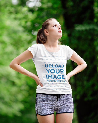 T-Shirt Mockup Featuring a Woman Exercising Outdoors