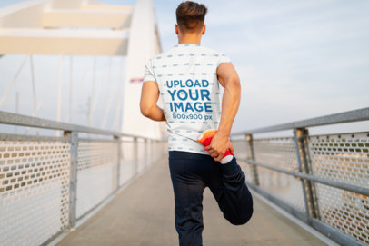 Back-View T-Shirt Mockup of a Man Stretching His Legs