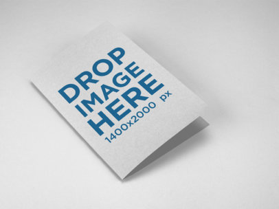 Mockup of a Bifold Brochure Lying on a Solid Color Surface