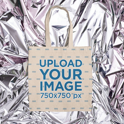 Mockup of a Flat Laid Tote Bag Over a Foil-Textured Surface m1165