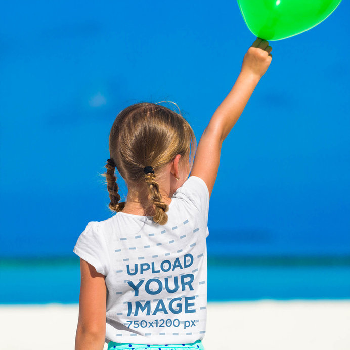 Back-View T-Shirt Mockup of a Girl Holding a Balloon at the Beach