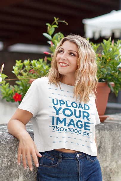 Crop Top T-Shirt Mockup of a Woman Posing by Some Plant Pots
