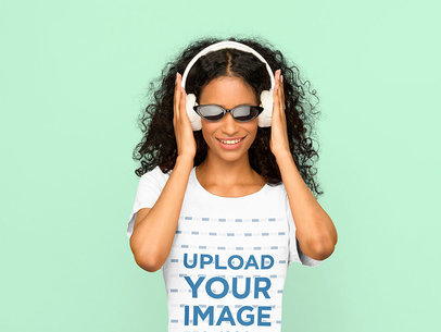 Tee Mockup of a Woman with Headphones at a Studio