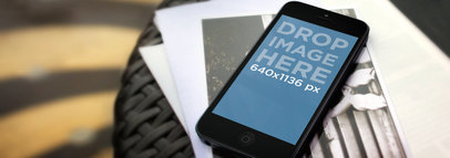 Mockup of an iPhone 5S Placed over a Textured Table