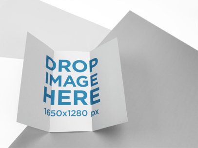 Open Trifold Brochure Mockup Lying on a Multicolor Surface