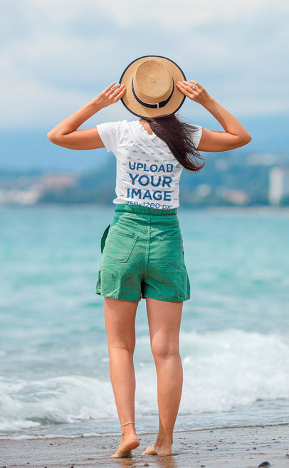 Back-View T-Shirt Mockup Featuring a Woman at the Beach