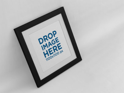 Mockup of an Angled Art Print on a Pastel Color Wall