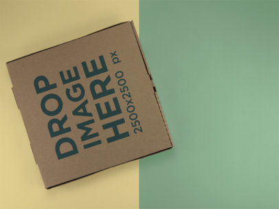 Top Shot Mockup of a Pizza Box Lying on a Two Colors Surface