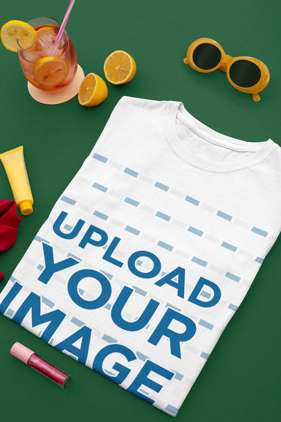Mockup of a Folded T-Shirt Next to a Cocktail