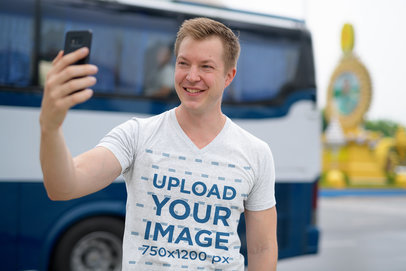 V-Neck Tee Mockup Featuring a Smiling Man Taking a Selfie 